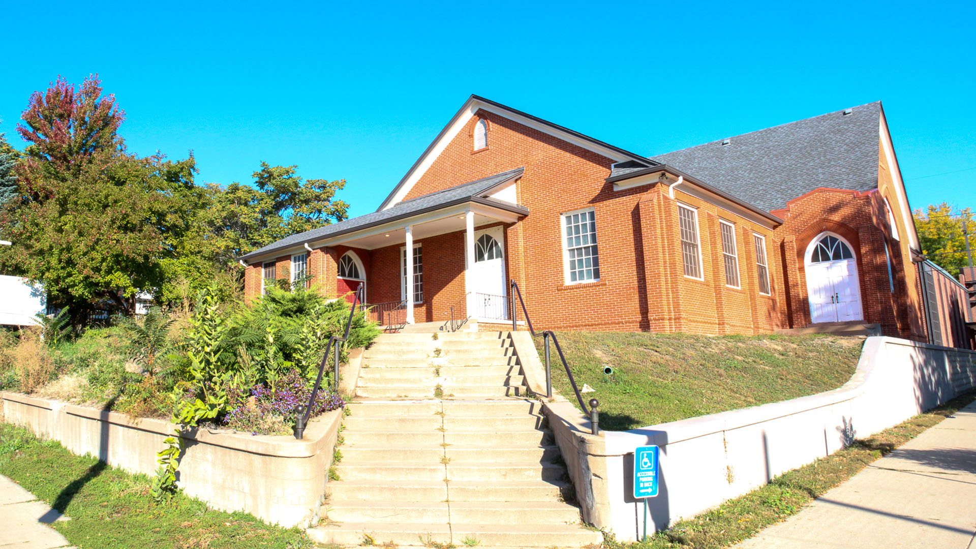 A photo of the front of our building. South facing walls of an old brick structure warm in the morning sun light.